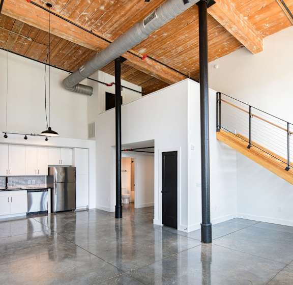 A patio with tables and chairs is covered by a roof at Judson Mill Lofts, Greenville, SC 29611