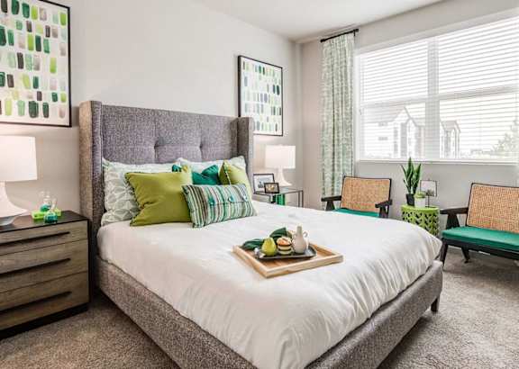a bedroom with a large bed and a window