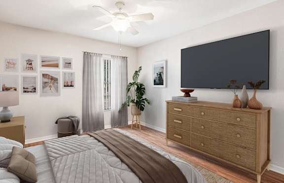 A bedroom with a bed, dresser, and a ceiling fan.