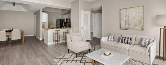 A living room with a white couch and a coffee table at San Mareno at Mirasol.