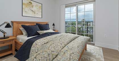 A bedroom with a large bed and a view of the ocean.