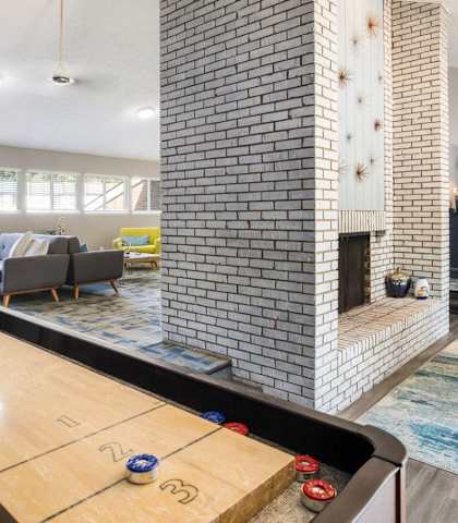 a pool table in a living room with a fireplace at Foote Hills Apartments - Grand Rapids, MI Apartments, Grand Rapids, MI, 49546
