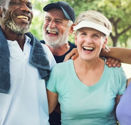 a group of older people laughing and posing for a picture
