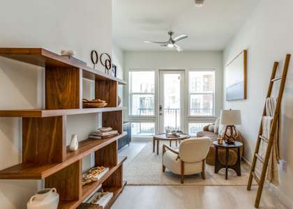 A living room with a white ceiling and a fan.