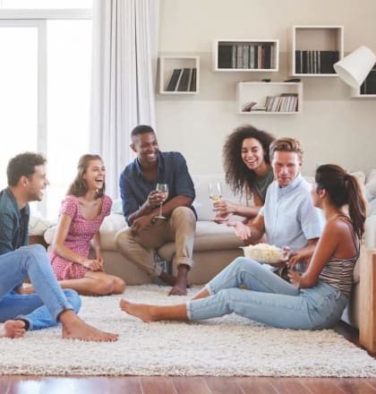 a group of people sitting on the floor in a living room