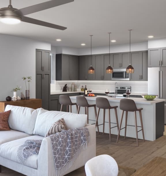 A modern living room with a kitchen area in the background at Elevation San Tan, Gilbert, AZ, 85295