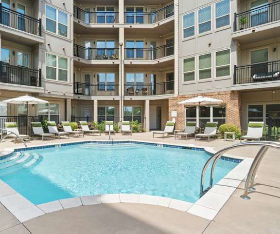 A large swimming pool in front of apartment buildings at The Linden Apartments, Davidson, NC, 28036