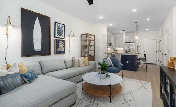 A living room with a grey couch and a coffee table.
