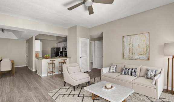 A living room with a white couch and a coffee table at San Mareno at Mirasol.
