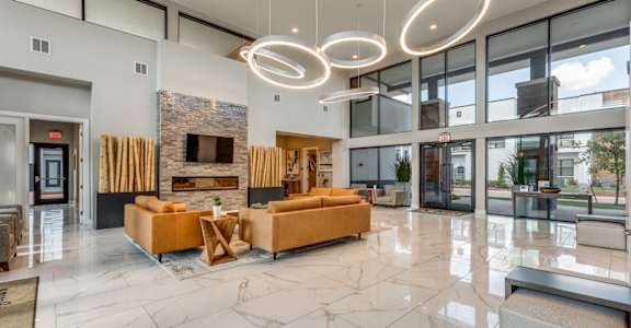 A spacious lobby with a fireplace and seating area.