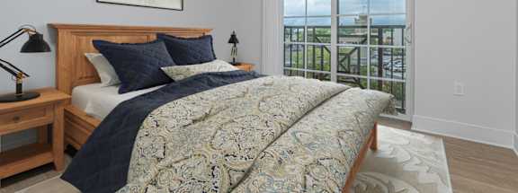 A bedroom with a large bed and a view of the ocean.