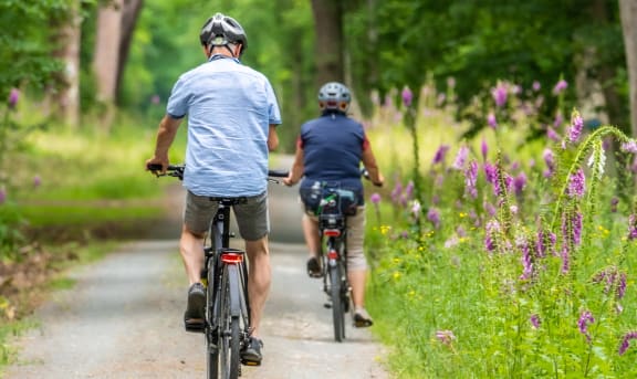 a man and a woman riding bikes on a trail