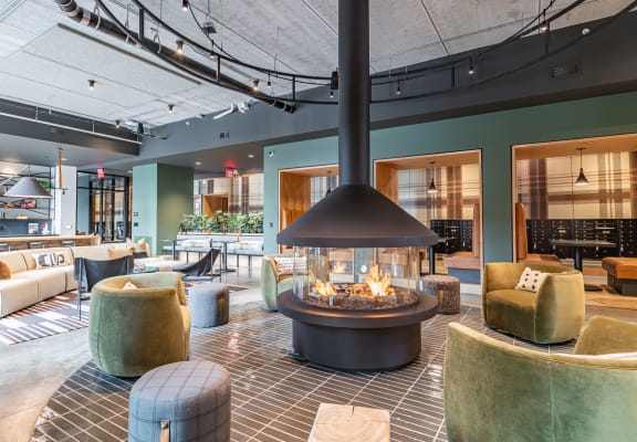 the lobby of a hotel with a large fire pit