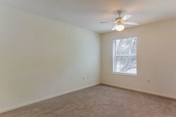 Carpeted Bedroom with Window and Ceiling Fan
