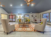 Thumbnail 18 of 27 - Clubhouse lobby with seating areas and modern decor at The Colony Apartments, Universal City, 78148