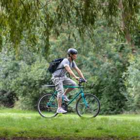 Cyclist riding through Clissold Park in North London.