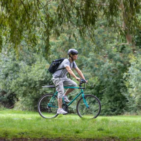 Cyclist riding through Clissold Park in North London.