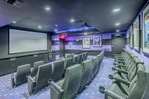 Lofts at Lakeview Apartments - Theater room with reclining leather seats