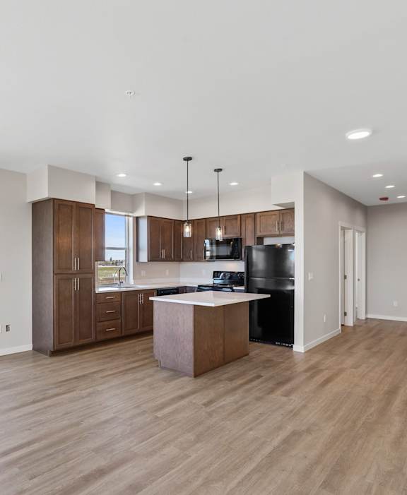 A modern kitchen with wooden cabinets and a central island.