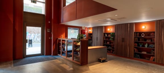 the lobby of a building with a reception desk and a door