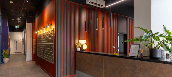 the lobby of a building with a reception desk and a door