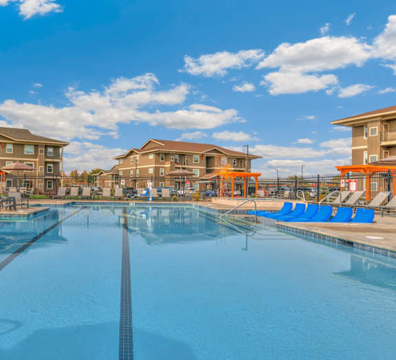 RedPoint Apartments Pool Area with Lounge Chairs and Apartment Buildings