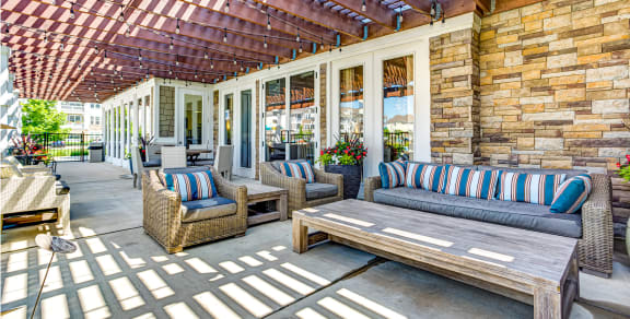 a patio with wicker furniture and a pergola