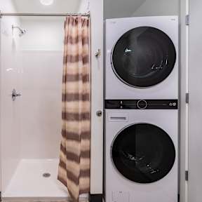 A row of washing machines with the number 35 on the front of the second one from the right.