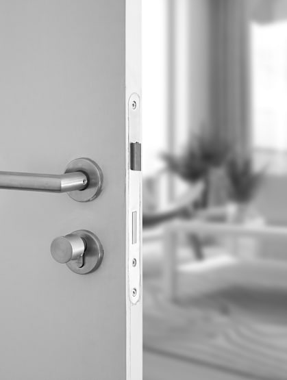 A white door with a handle and a lock.