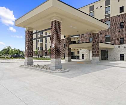 A large building with a covered walkway in front.