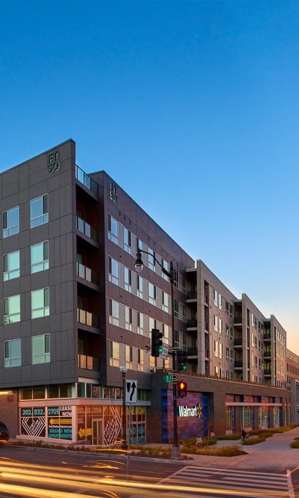 a large building on the corner of a city street at sunset at Fort Totten Square, Washington, Washington DC