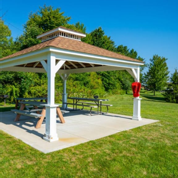 a pavilion with a picnic table and a fire hydrant