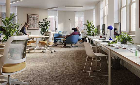 A modern office space with people working at their desks.