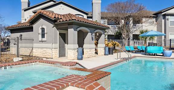 A pool with a small building next to it.