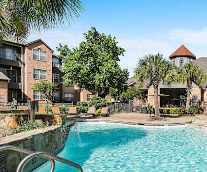 A swimming pool in front of a resort.