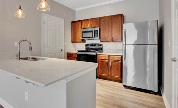a kitchen with an island and stainless steel appliances