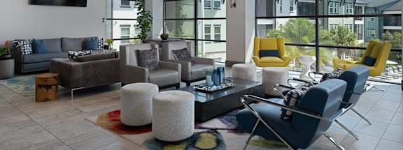 A living room with a grey couch and yellow chairs.