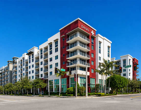 A multi-story building with a red and white facade is the main focus of the image.