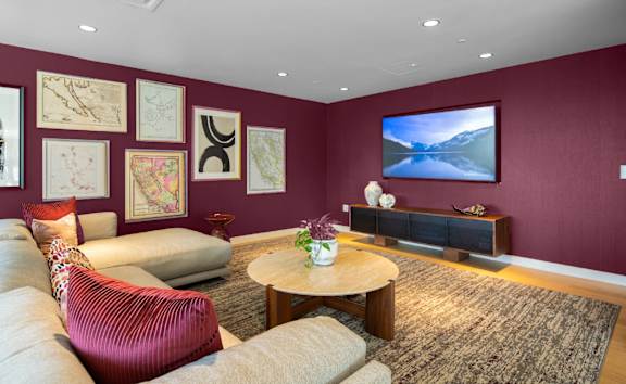 A living room with a red chair and a brown coffee table.