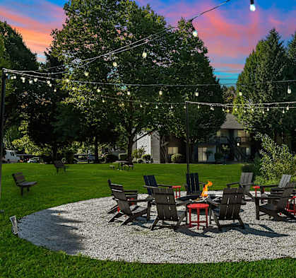 a patio with a table and chairs under lights at Woodlake Apartments, Washington 98034