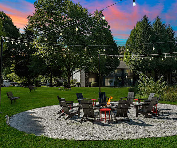 a patio with a table and chairs under lights