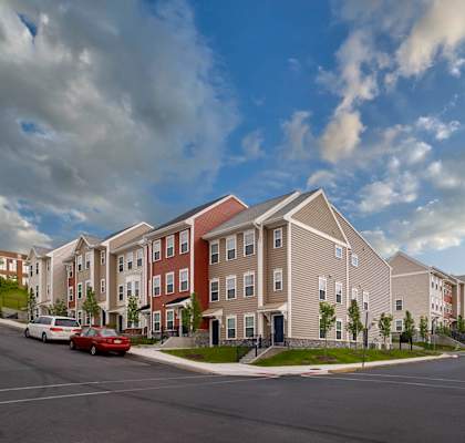 a rendering of a row of townhouses on a street corner