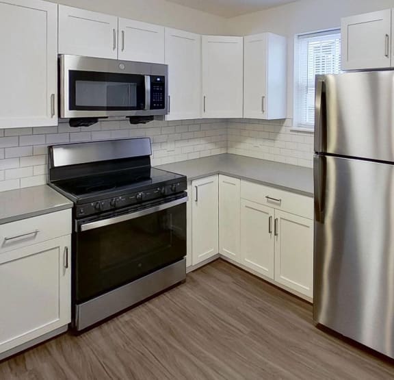 a bedroom with a bed and a ceiling fan  at Signature Pointe Apartment Homes, Athens