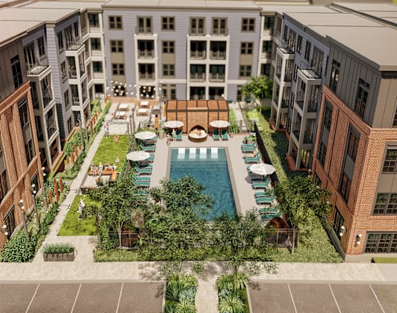 A large courtyard surrounded by buildings with a pool in the middle.