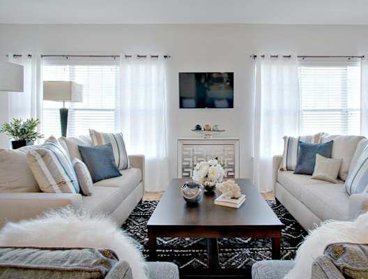 A living room with two couches, a coffee table, and a television at Hillside Club Apartments, Livingston, NJ, 07039
