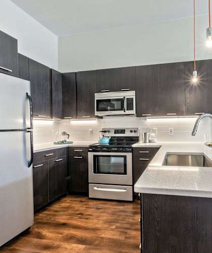 Kitchen with stainless steel appliances and white counter tops at Delo Apartments, Louisville, CO, Colorado, 80027