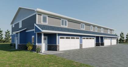 a blue house with a garage and a driveway