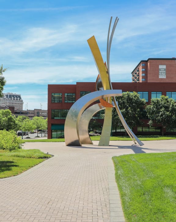 a large metal sculpture in the middle of a park at Symphony Center Apartments, Baltimore, MD, 21201