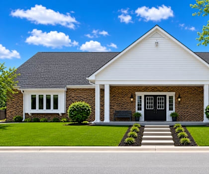 A white house with a black door and windows.