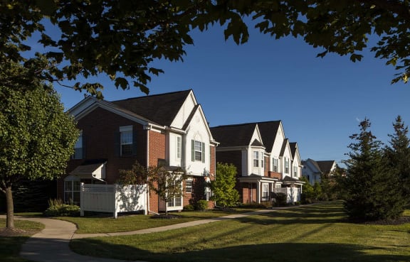a row of houses in a suburban neighborhood at Wyndchase, Canton, MI